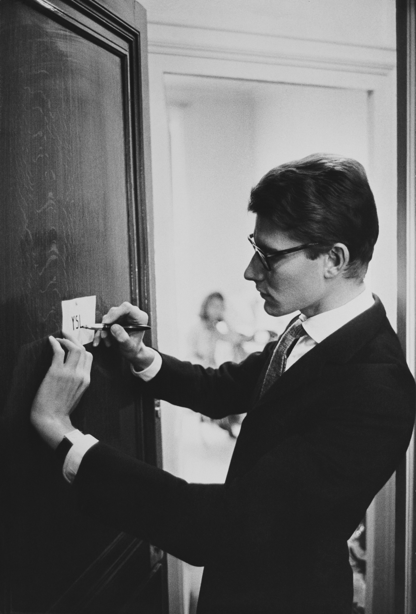 Yves Saint Laurent signant ses initiales YSL